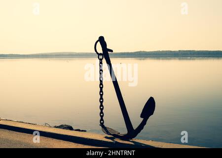 Anchor on the shore. anchor stands on the pier. marine background Stock Photo