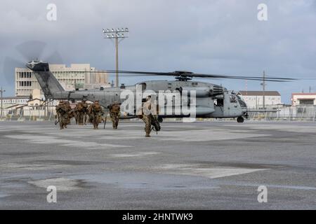 U.S. Marines with Fleet Anti-Terrorism Security Team (FASTPAC), exit a CH-53E Super Stallion at Naha Military Port, Okinawa, Japan, Feb. 8, 2022. The FASTPAC conducted an insert and perimeter set up in preparation for a 31st Marine Expeditionary Unit Certification Exercise. (U.S. Marine Corps photo by Cpl. Francesca Landis) Stock Photo
