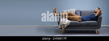 Photo Of Man Relaxing On Sofa At Home Stock Photo