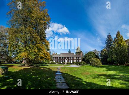 view to scenic old victorian wooden buildings in East Hampton with green grass and scenic balconies Stock Photo