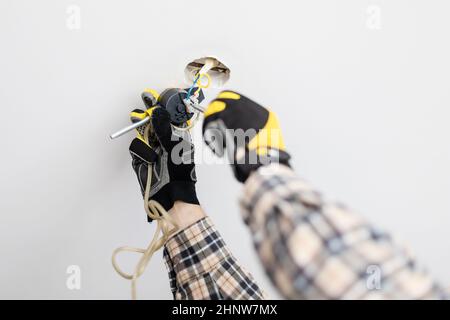 electrician repairing suspend of ceiling lamp at home Stock Photo