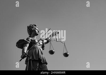 lady justice with sword and scale symbolizes justice Stock Photo