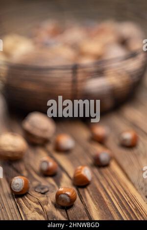 different kinds of nuts on a wooden background Stock Photo