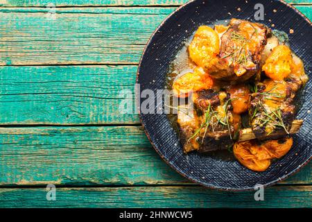 Beef ribs stewed in apricots. Veal meat with fruit sauce Stock Photo