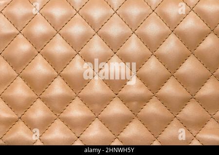 Golden colour shiny leather material pattern texture background Stock Photo