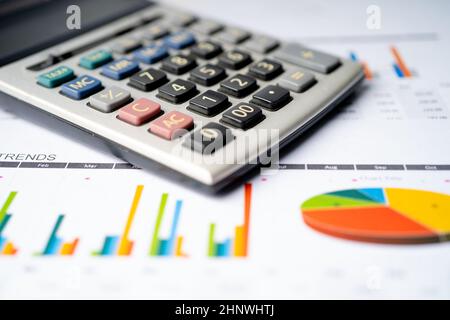 Calculator on charts and graphs paper. Finance, Account, Statistics, Analytic research data and Business company meeting concept Stock Photo