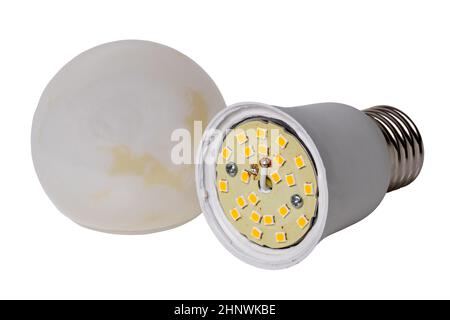 Defective bulbs. Close-up of an exploded led lamp with burn marks on the plus and minus connecting wires isolated on a white background. Clipping path Stock Photo