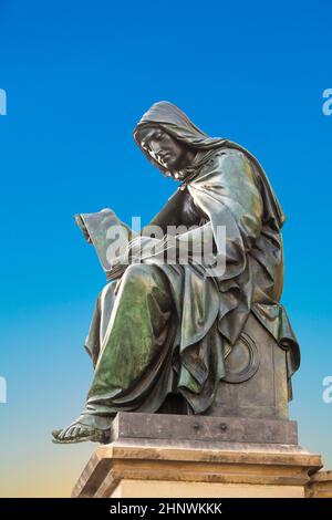 statue of Johannes Gutenberg at gutenberg fountain from 1840  in Frankfurt with the allegory of theology Stock Photo