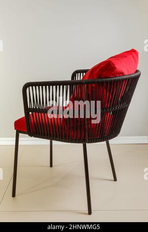 Contemporary wicker kitchen armchair with velour upholstery. Stock Photo