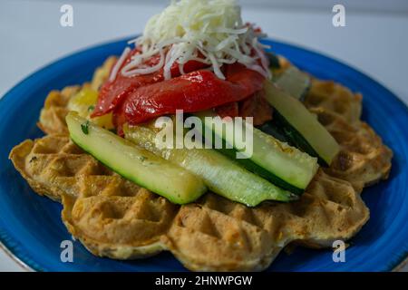 vegan waffles with fruit, vegetables and almond flour batter on a white background.