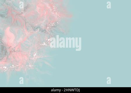 Delicate pink marbled paint edged with white accents on a pale blue background. Stock Photo