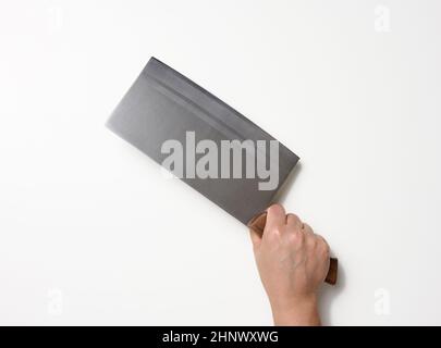 female hand holding a large sharp kitchen knife for cutting meat on a white background Stock Photo