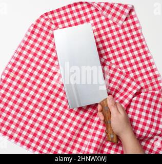 female hand holding a large sharp kitchen knife for cutting meat on a white background Stock Photo