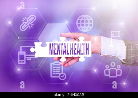 Hand writing sign Mental Health, Business concept persons condition regard to their psychological well being Hand Holding Jigsaw Puzzle Piece Unlockin Stock Photo