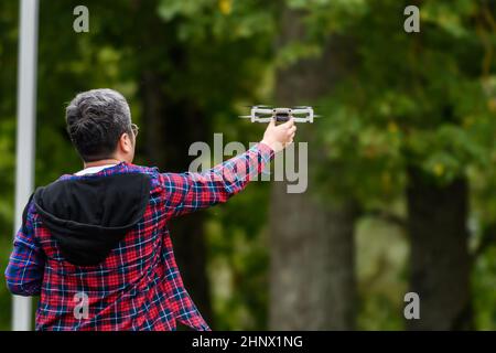 CESIS, LATVIA. 27th August 2021. Selective focus photo. A man holds small drone in hand. Stock Photo