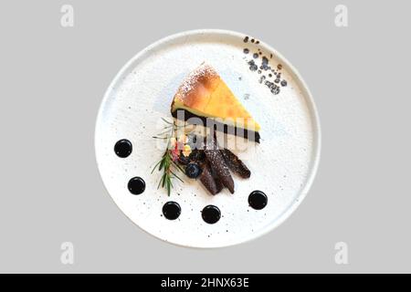 A piece of homemade raw chocolate cheesecake or mousse cake on white plate Stock Photo