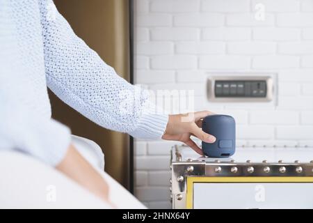 close-up on portable wireless speaker in hand on table, new technology speaker easy to use Stock Photo