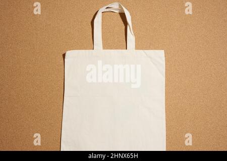 empty linen eco friendly beige canvas tote bag for branding on brown  background. Clear reusable bag for groceries, mock up. Flat lay Stock Photo  - Alamy