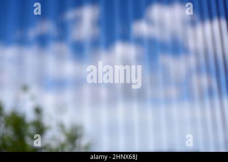 blurry view blue sky with cloud through soft white curtain from bedroom. abstract  blue sky with cloud blurry bakground. Out of focus background - nat Stock Photo