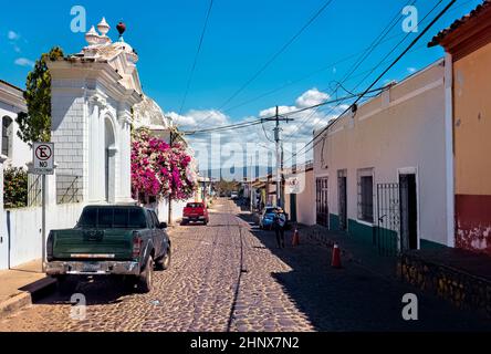 Cobblestone street and the colonial Santa Lucia church in Suchitoto, El Salvador Stock Photo