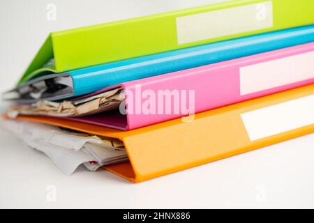 File Folder Binder stack of multi color on table in business office. Stock Photo