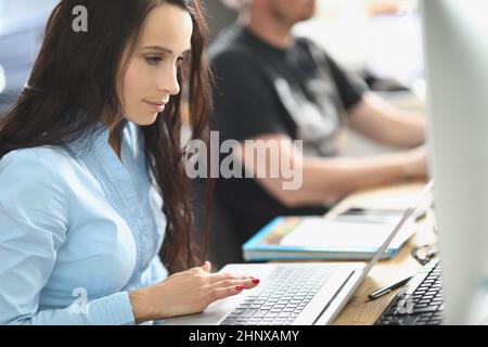 Call center team working at desks in the office Stock Photo