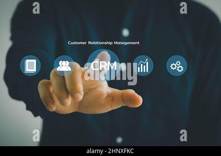 Hand touching CRM  Customer relationship management automation system software.business technology on virtual screen concept. Stock Photo