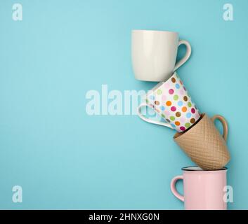 stack of empty ceramic cup on a blue background, flat lay Stock Photo