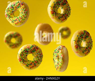 round baked donuts sprinkled with multicolored sugar sprinkle levitate on a yellow background Stock Photo