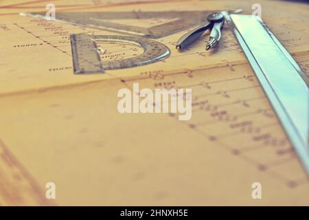 Electrical engineer workplace - electrotechnical project, rulers, and divider compass. Construction and electrotechnology concept. Engineering tools. Stock Photo