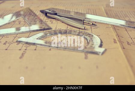 Electrical engineer workplace - electrotechnical project, rulers, and divider compass. Construction and electrotechnology concept. Engineering tools. Stock Photo