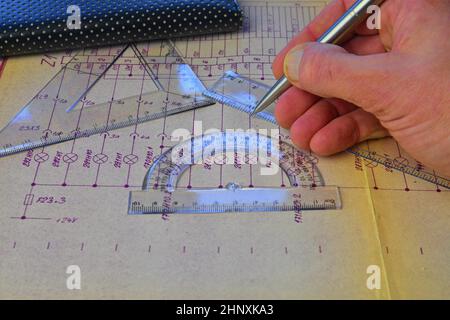 Electrical engineer workplace - electrotechnical project, rulers, and divider compass. Construction and electrotechnology concept. Engineering tools. Stock Photo