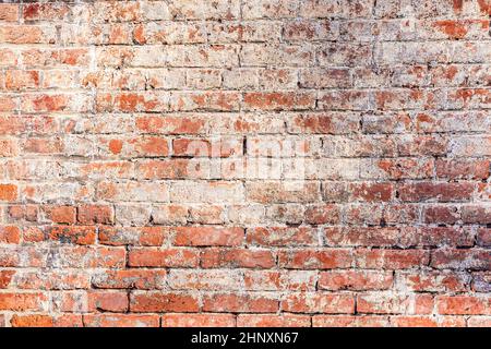old red grungy brick wall gives a harmonic structure Stock Photo