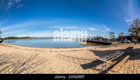 scenic view to beach and harbor of Sag Harbor in afternoon light Stock Photo