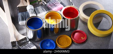 Paint cans and paintbrushes of different size  for home decorating purposes. Stock Photo