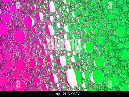 Magenta and green bubbles background. Foam bubbles macro texture. Stock Photo
