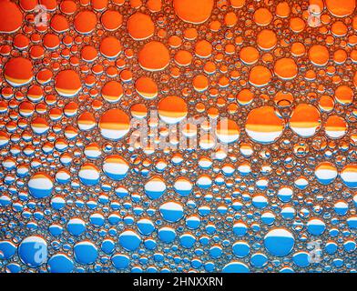 Orange and blue bubbles background. Foam bubbles macro texture. Stock Photo