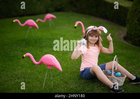 Easter bunny child boy with cute face. Kids hunting easter eggs. Easter egg hunt. Stock Photo