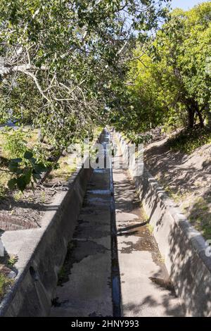 Sewage, water pipeline, river, drain. Street in the town of Claremont, Cape Town, South Africa. Stock Photo