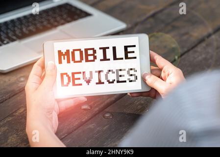 Hand writing sign Mobile Devices, Word for A portable computing device like smartphone tablet computer Voice And Video Calling Capabilities Connecting Stock Photo