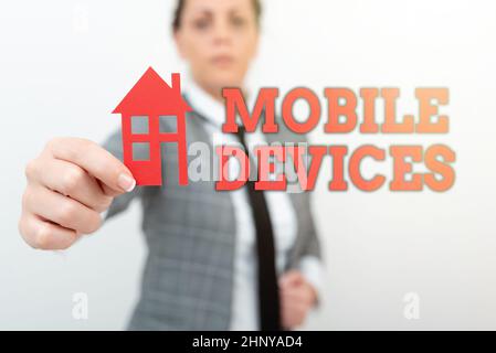 Handwriting text Mobile Devices, Word Written on A portable computing device like smartphone tablet computer Real Estate Agent Selling New Property, A Stock Photo