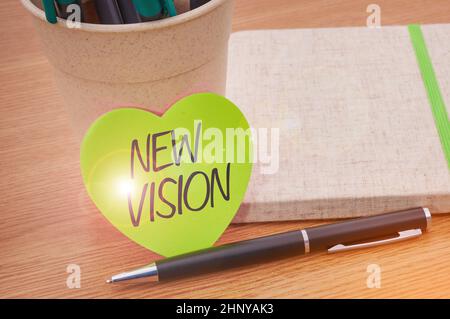 Conceptual display New Vision, Business concept seeing some future developments Hopeful about the future Plain Blank Open Notebooks With Stack Of Pens Stock Photo