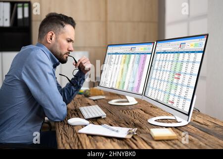 Computer Spreadsheet Data Analyst Man Using Multiple Screens Stock Photo