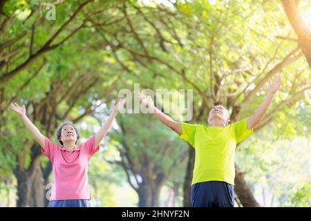Senior couple taking a deep breath in the park Stock Photo