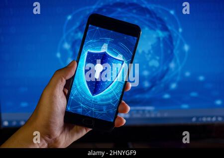 Shield Internet phone Smartphone is protected from hacker attacks, Firewall Businesspeople press the protected phone on the internet. space put messag Stock Photo