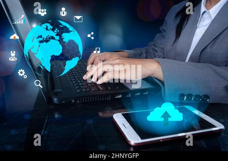 The phone has a cloud icon. Press enter button on the computer. business logistics Communication network World map send message Connect worldwide hand Stock Photo