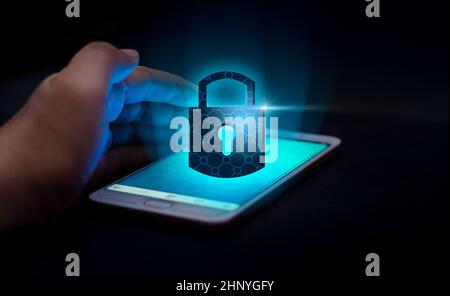Unlocked smartphone lock Internet phone hand  press the phone to communicate in the Internet. Cyber security concept hand protection network with lock Stock Photo