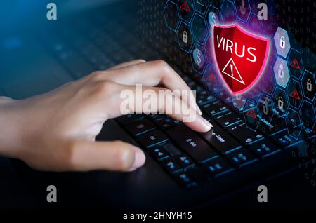Press enter button on the keyboard computer Protective shield virus red Exclamation Warning Caution Computer in dark with word virus Stock Photo
