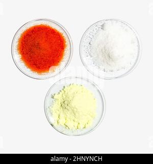 Potassium Dichromate, Di-Ammonium Prosphate and Sulfur Powder in Chemical Watch Glass. Close up chemical ingredient on white laboratory table. Top Vie Stock Photo