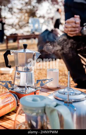 Man Preparing Coffee in a Moka Pot Outdoor. Stock Photo
